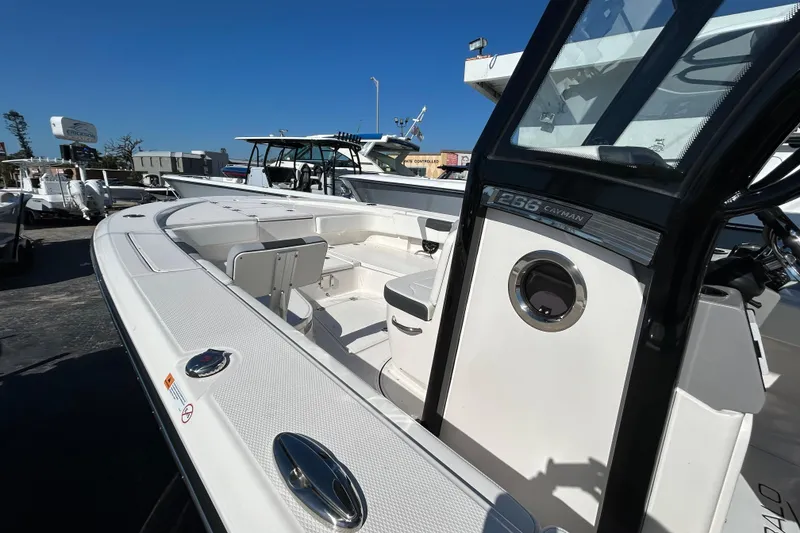 Slide: The Image of 2025 Robalo 266 Cayman boat, sleek design, spacious deck, modern features, outdoor display. - 10