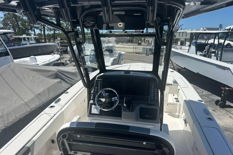 Slide: The Image of 2025 Robalo 266 Cayman boat cockpit with steering wheel and control panel. - 11