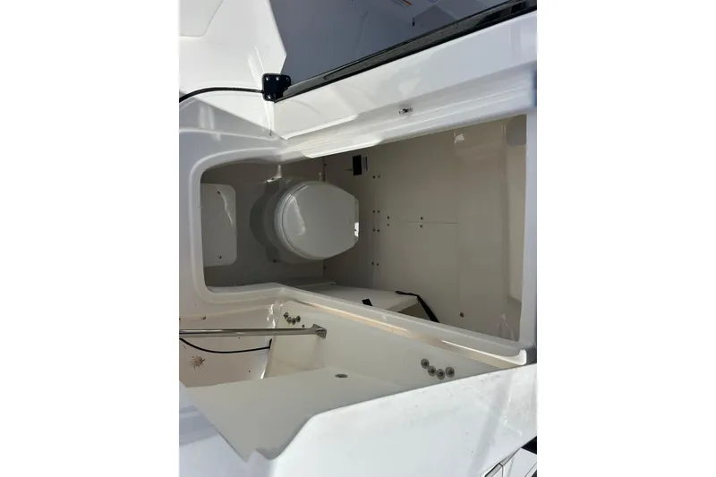 Slide: The Image of Interior view of 2025 Robalo 266 Cayman boat compartment with storage space. - 13