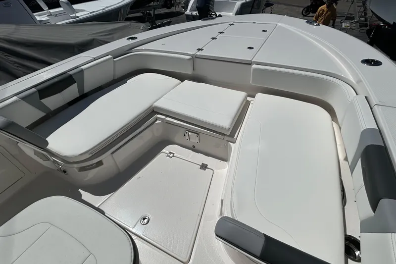 Slide: The Image of 2025 Robalo 266 Cayman boat interior with cushioned seating and storage compartments. - 14