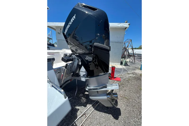 Slide: The Image of 2025 Robalo 266 Cayman boat with Mercury outboard motor, parked outdoors. - 18