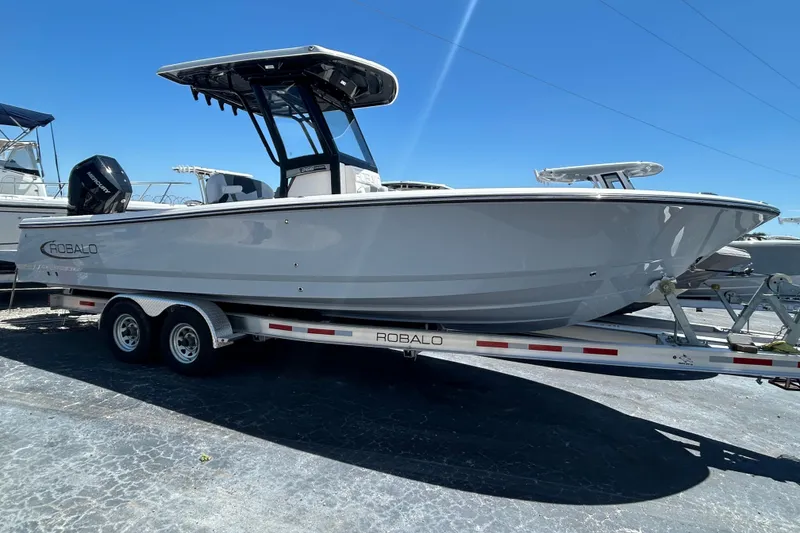 Slide: The Image of 2025 Robalo 266 Cayman boat on trailer under clear blue sky. - 3