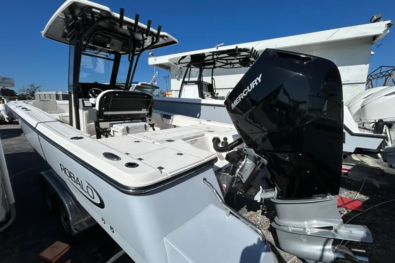 Slide: The Image of 2025 Robalo 266 Cayman boat with Mercury engine, displayed outdoors. - 5