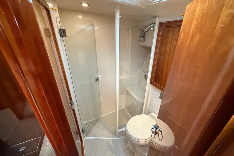 Slide: The Image of Luxurious bathroom in 2004 Riviera 51 Flybridge yacht with shower and toilet. - 24