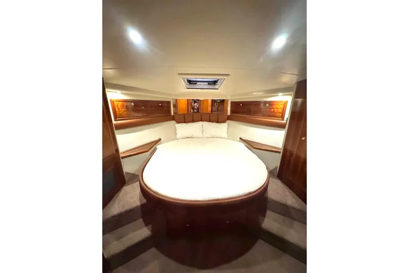 Slide: The Image of Luxurious cabin interior of 2004 Riviera 51 Flybridge yacht with elegant wood finishes. - 17