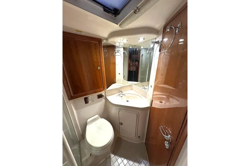 Slide: The Image of Luxurious bathroom in 2004 Riviera 51 Flybridge yacht with wood accents and modern fixtures. - 18