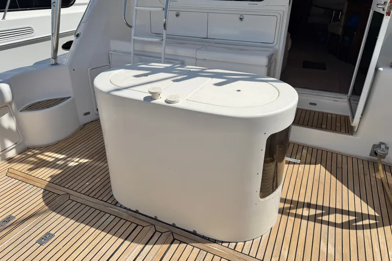 Slide: The Image of 2004 Riviera 51 Flybridge yacht deck with seating and storage area. - 32