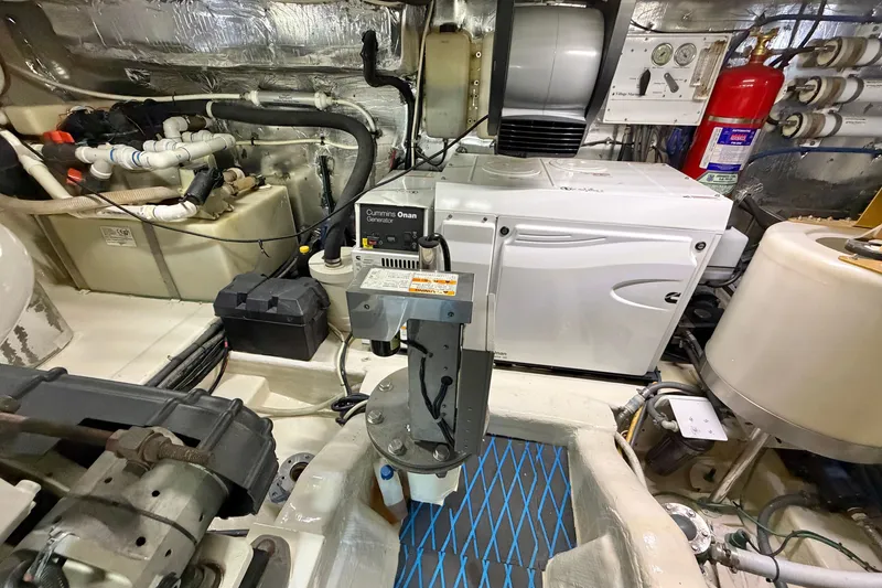 Slide: The Image of Engine room of 2004 Riviera 51 Flybridge with Cummins Onan generator and various equipment. - 35