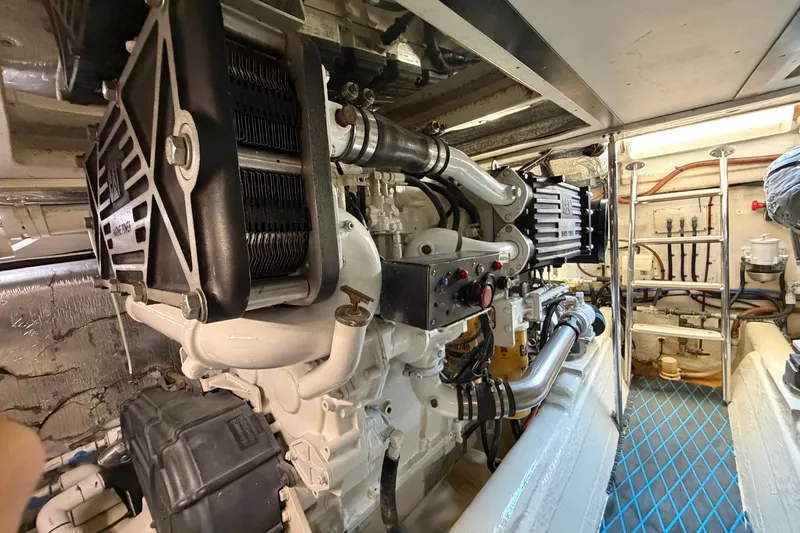 Slide: The Image of Engine room of a 2004 Riviera 51 Flybridge yacht, showcasing mechanical components. - 43