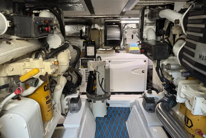 Slide: The Image of Engine room of a 2004 Riviera 51 Flybridge yacht, featuring mechanical components and equipment. - 20