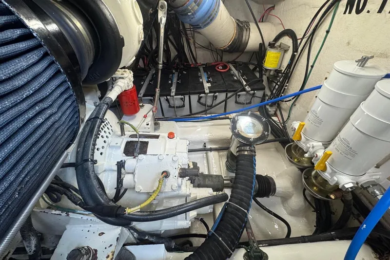 Slide: The Image of Engine room of 2004 Riviera 51 Flybridge yacht, showcasing mechanical components and wiring. - 23