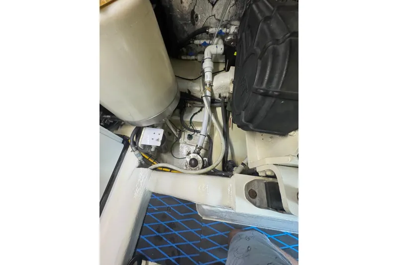 Slide: The Image of Engine compartment of a 2004 Riviera 51 Flybridge boat, showcasing mechanical components. - 25