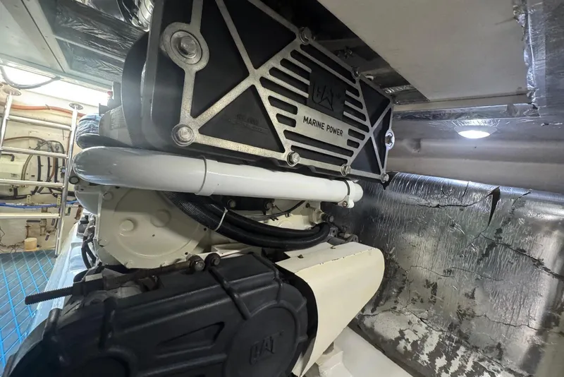Slide: The Image of Engine room of a 2004 Riviera 51 Flybridge yacht, showcasing marine power components. - 26
