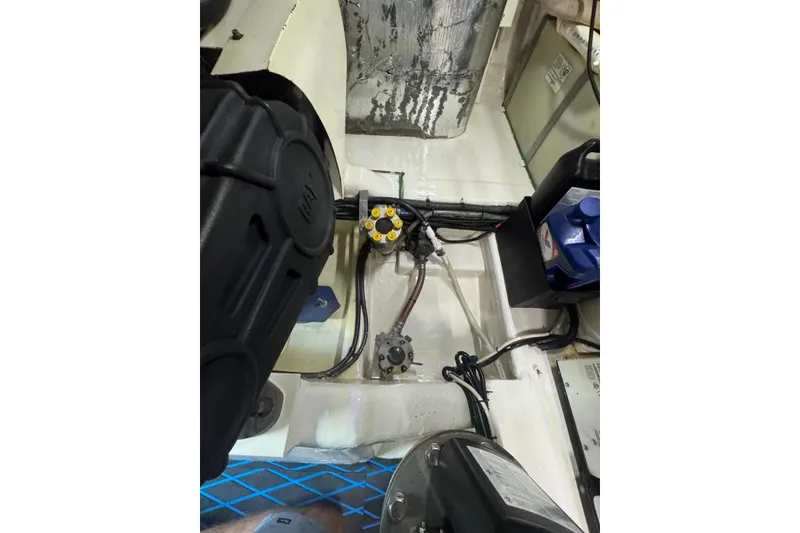 Slide: The Image of Engine compartment of 2004 Riviera 51 Flybridge, showcasing mechanical components and wiring. - 27