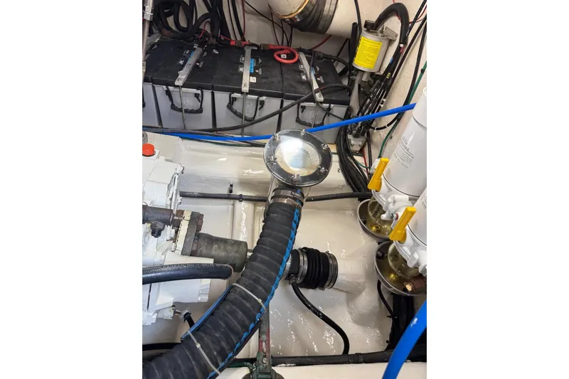 Slide: The Image of Engine room of 2004 Riviera 51 Flybridge with visible components and wiring. - 28