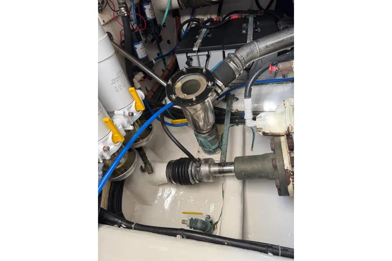 Slide: The Image of Engine room of 2004 Riviera 51 Flybridge with visible mechanical components. - 29