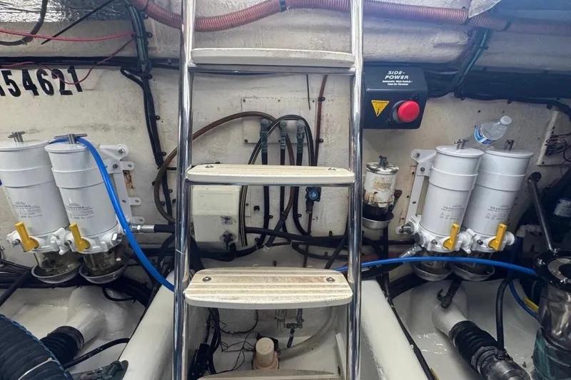 Slide: The Image of Engine room of 2004 Riviera 51 Flybridge with fuel filters and ladder. - 30