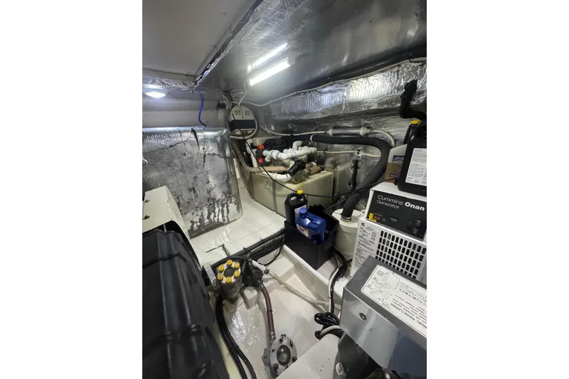 Slide: The Image of Engine room of 2004 Riviera 51 Flybridge with Cummins Onan generator and insulated walls. - 34