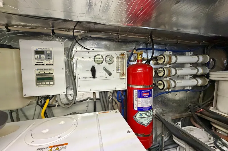 Slide: The Image of Engine room of 2004 Riviera 51 Flybridge with control panels and fire extinguisher. - 40