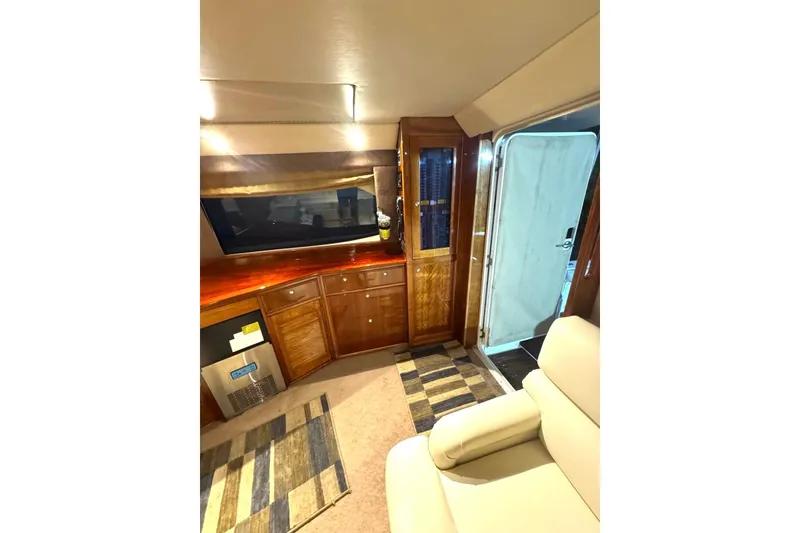 Slide: The Image of Interior of 2004 Riviera 51 Flybridge yacht with wooden cabinetry and modern decor. - 4