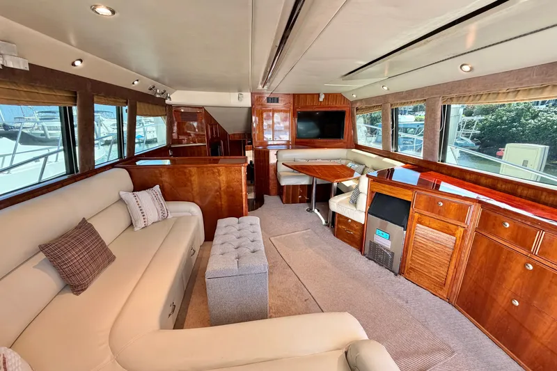 Slide: The Image of Luxurious interior of 2004 Riviera 51 Flybridge yacht with elegant wood finishes and plush seating. - 7