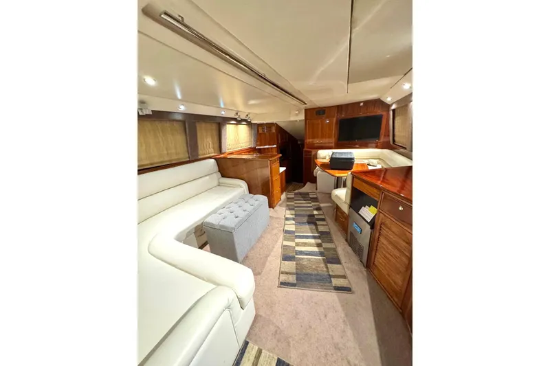 Slide: The Image of Luxurious interior of 2004 Riviera 51 Flybridge yacht with elegant seating and wood finishes. - 5