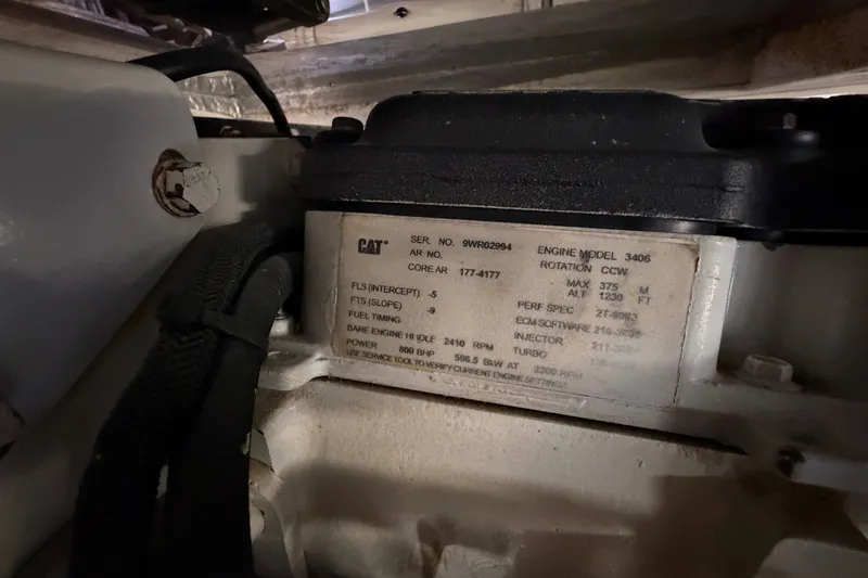 Slide: The Image of Engine compartment of a 2004 Riviera 51 Flybridge, featuring CAT engine model 3406. - 48