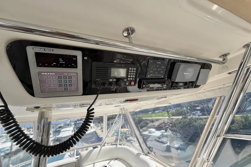 Slide: The Image of 2004 Riviera 51 Flybridge cockpit electronics with navigation and communication equipment. - 31