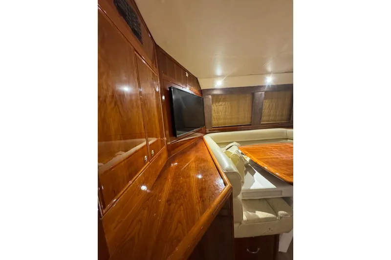 Slide: The Image of Luxurious interior of 2004 Riviera 51 Flybridge yacht with polished wood finish. - 8