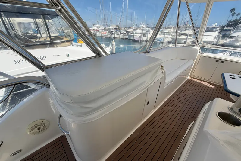 Slide: The Image of 2004 Riviera 51 Flybridge yacht interior with seating and marina view. - 30
