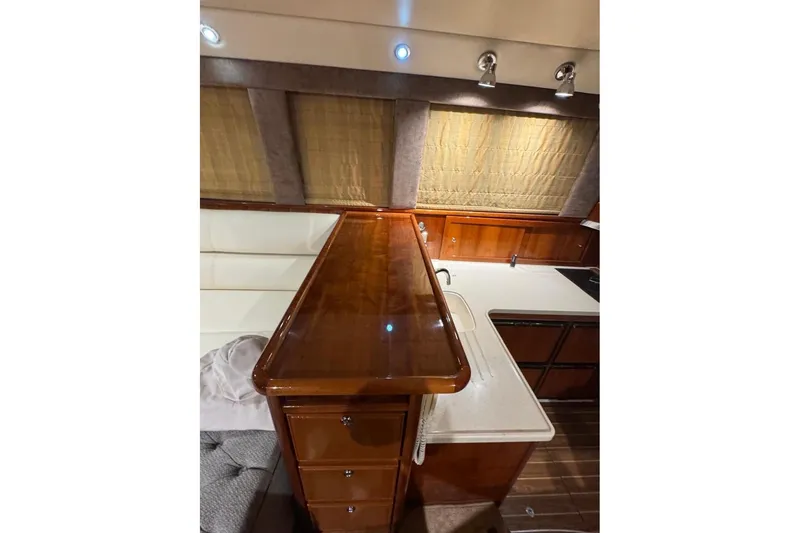 Slide: The Image of Luxurious interior of 2004 Riviera 51 Flybridge yacht with polished wood and modern fixtures. - 9