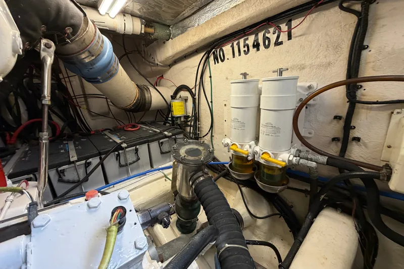 Slide: The Image of Engine room of 2004 Riviera 51 Flybridge with visible filters and wiring. - 41