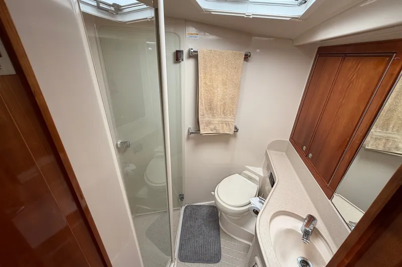 Slide: The Image of Bathroom interior of 2004 Riviera 51 Flybridge yacht with shower, sink, and toilet. - 20