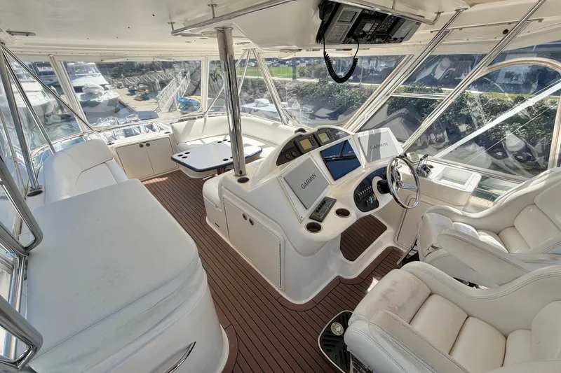 Slide: The Image of Luxurious 2004 Riviera 51 Flybridge interior with modern navigation equipment and plush seating. - 28