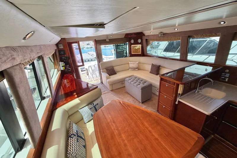 Slide: The Image of Luxurious interior of 2004 Riviera 51 Flybridge yacht with elegant seating and wooden finishes. - 11
