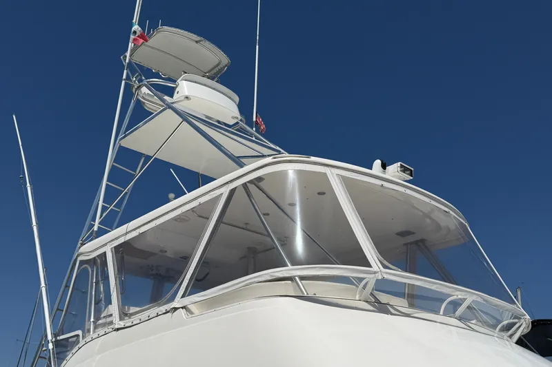 Slide: The Image of 2004 Riviera 51 Flybridge yacht against clear blue sky. - 3