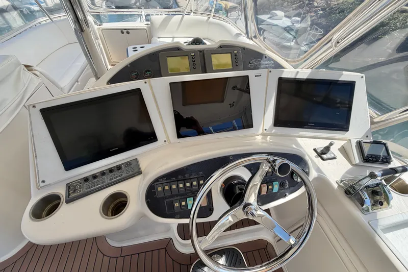 Slide: The Image of Helm of 2004 Riviera 51 Flybridge with navigation screens and controls. - 29