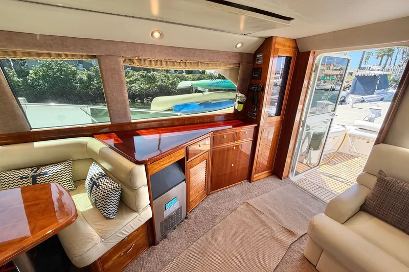 Slide: The Image of Luxurious interior of 2004 Riviera 51 Flybridge yacht with elegant wood finishes and plush seating. - 9