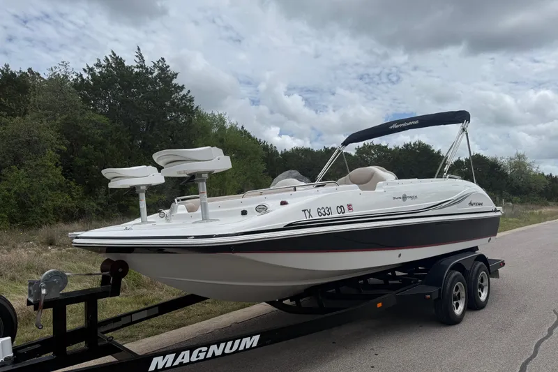 Slide: The Image of 2014 Hurricane SunDeck Sport 202 IO boat on trailer, parked roadside. - 10