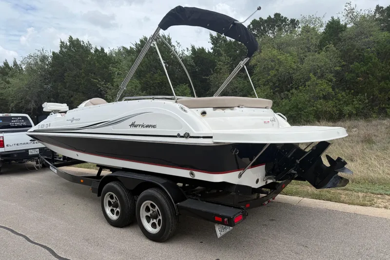 Slide: The Image of 2014 Hurricane SunDeck Sport 202 IO boat on trailer, parked on roadside. - 12