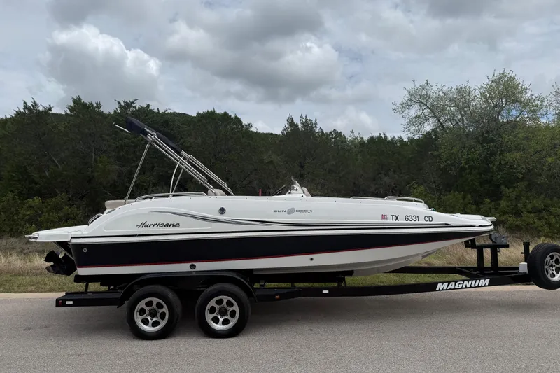 Slide: The Image of 2014 Hurricane SunDeck Sport 202 IO boat on trailer, parked on roadside. - 14