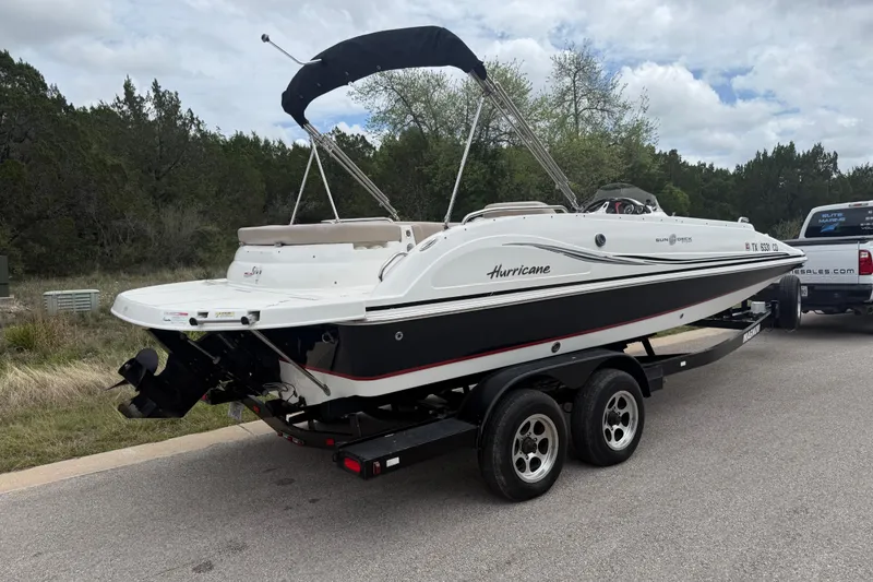 Slide: The Image of 2014 Hurricane SunDeck Sport 202 IO boat on trailer, parked on roadside. - 15