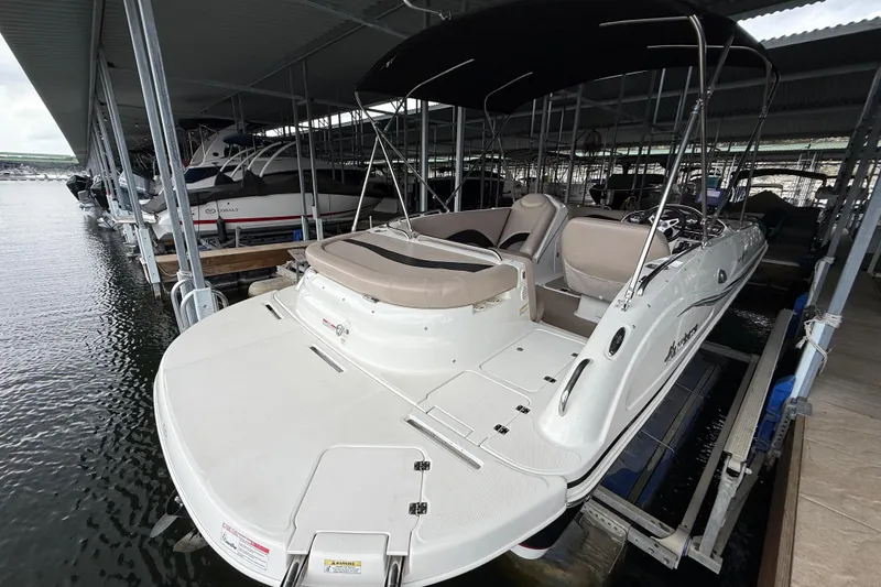 Slide: The Image of 2014 Hurricane SunDeck Sport 202 IO boat docked in a marina. - 17