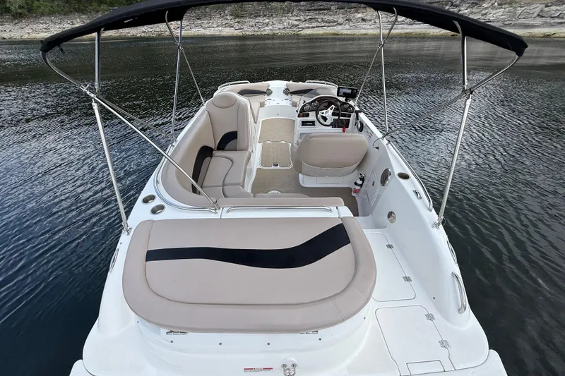 Slide: The Image of 2014 Hurricane SunDeck Sport 202 IO boat with seating and canopy on calm water. - 19