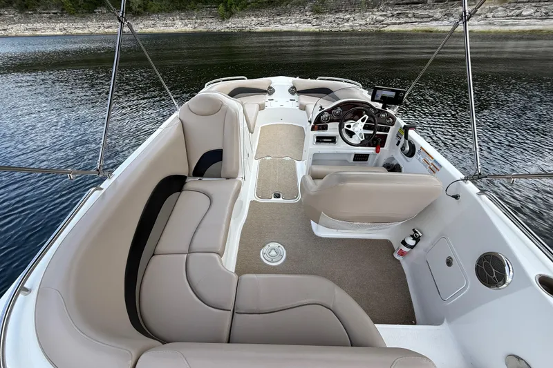 Slide: The Image of 2014 Hurricane SunDeck Sport 202 IO boat interior with beige seating and steering console. - 20