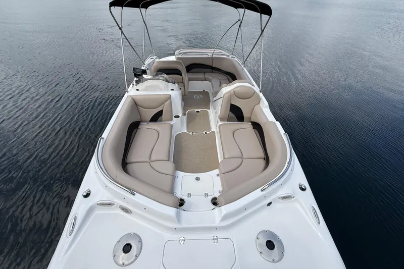 Slide: The Image of 2014 Hurricane SunDeck Sport 202 IO boat with spacious seating on calm water. - 21