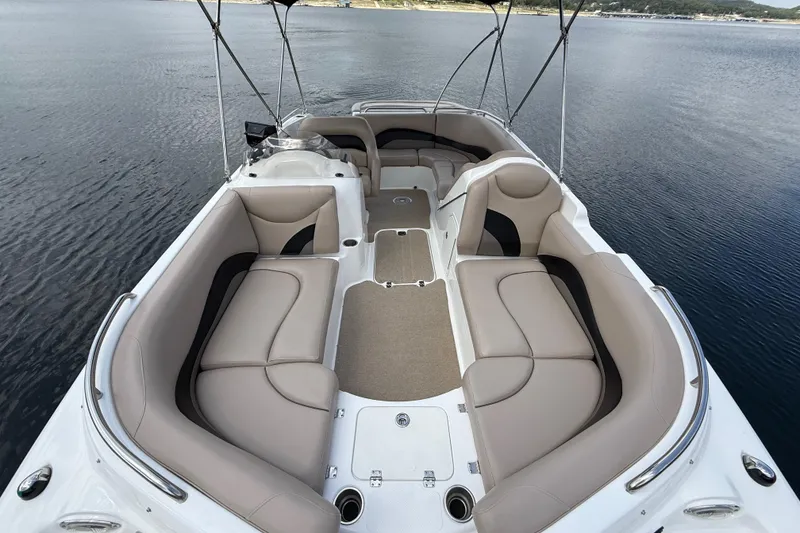 Slide: The Image of 2014 Hurricane SunDeck Sport 202 IO boat with spacious seating on calm water. - 22