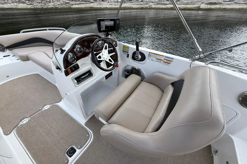 Slide: The Image of 2014 Hurricane SunDeck Sport 202 IO boat interior with steering wheel and seating. - 24