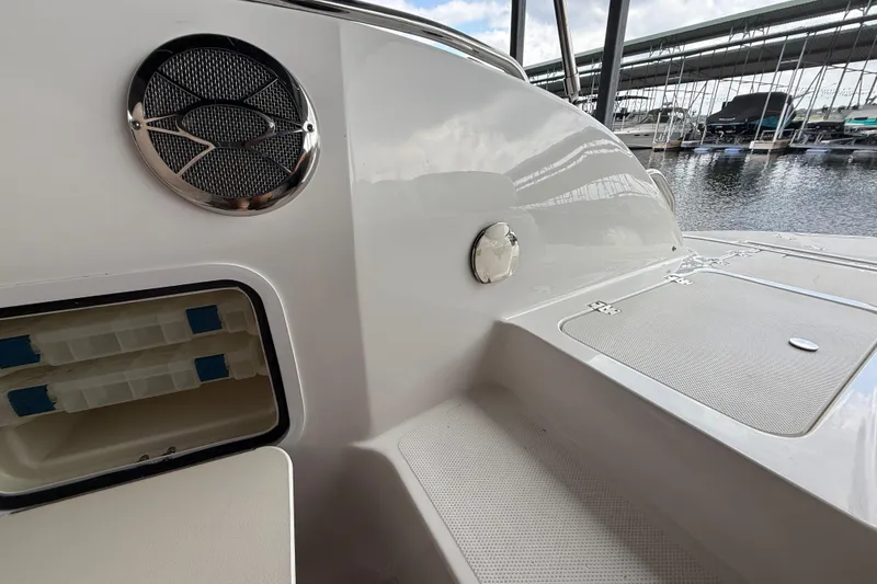 Slide: The Image of 2014 Hurricane SunDeck Sport 202 IO boat interior with speaker and storage compartment. - 27