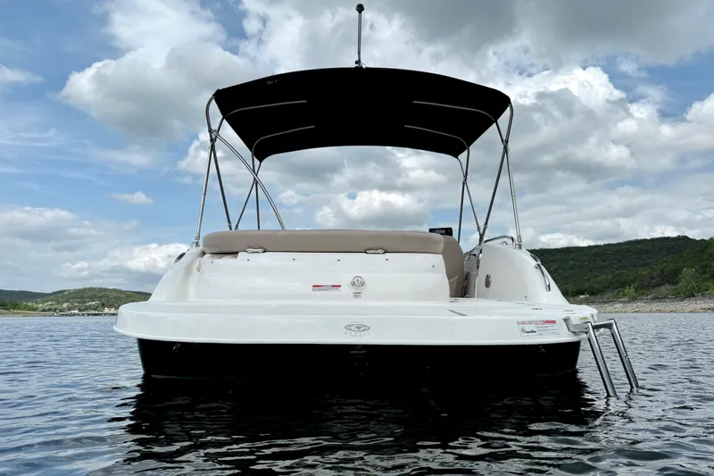 Slide: The Image of 2014 Hurricane SunDeck Sport 202 IO boat on water, under cloudy sky. - 5